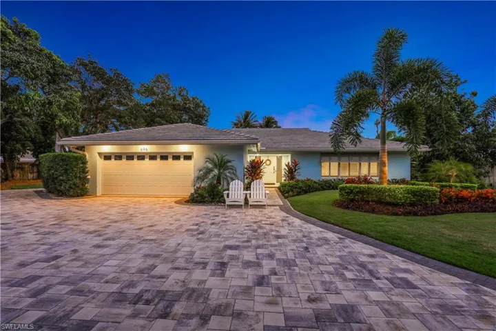 Ranch-style house with a front lawn and a garage
