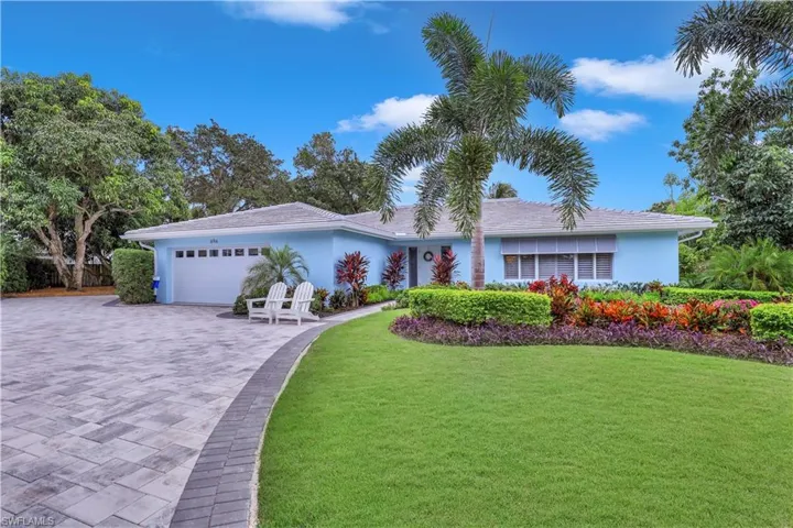 Ranch-style house with a garage and a front yard