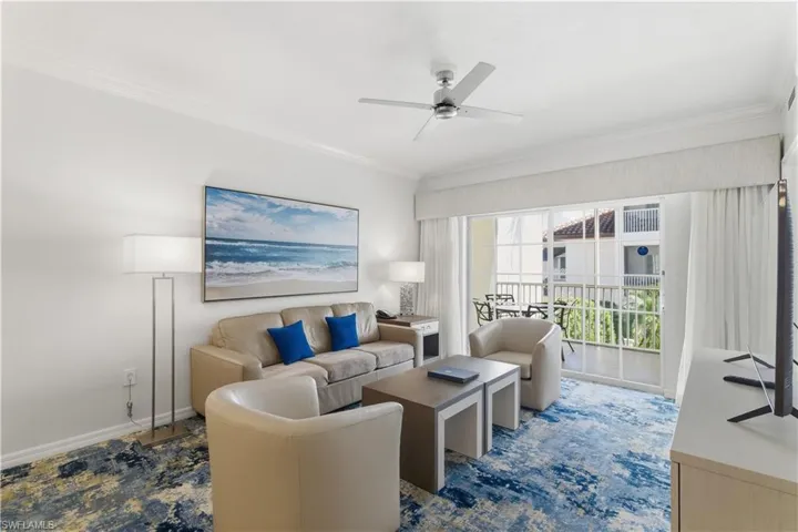 Living area featuring crown molding and ceiling fan