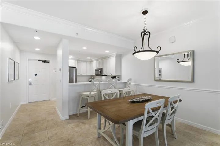 Dining space featuring recessed lighting, crown molding, and light tile patterned flooring