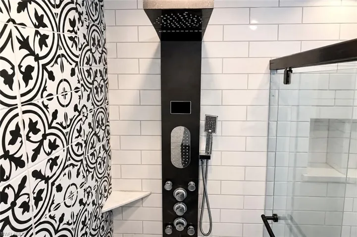 Modern shower system featuring a rainfall showerhead and handheld sprayer