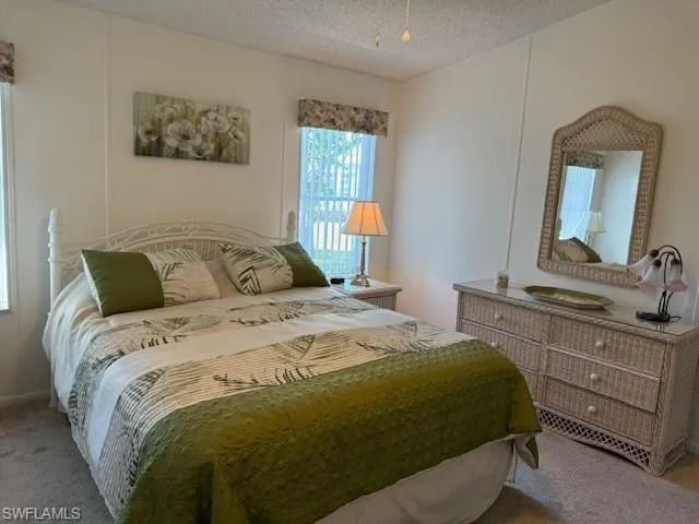 Bedroom with carpet flooring and a textured ceiling
