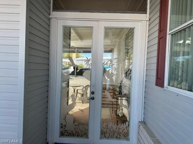 Doorway with wooden walls and french doors