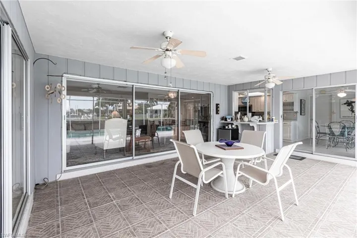 Sunroom / solarium featuring ceiling fan
