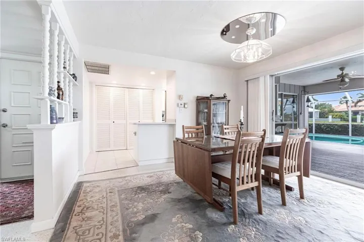 Carpeted dining space featuring ceiling fan