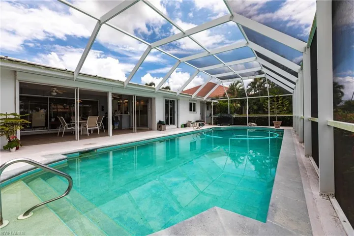 View of pool with a lanai and a patio area