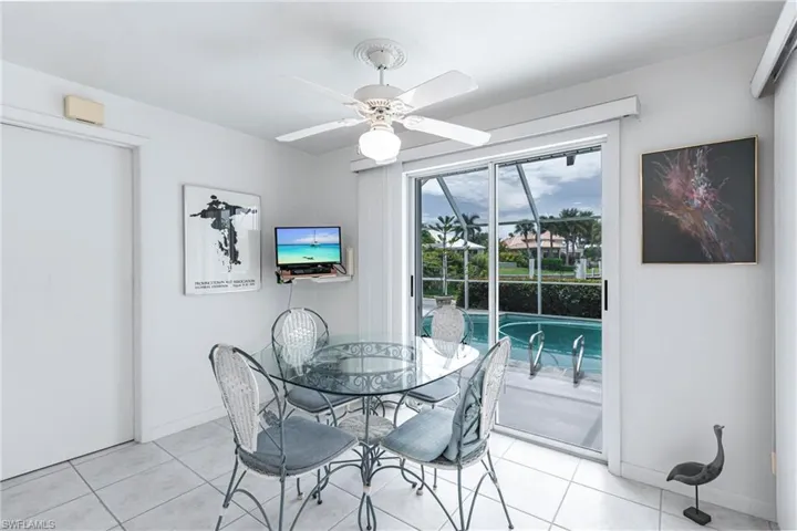 Tiled dining area featuring ceiling fan