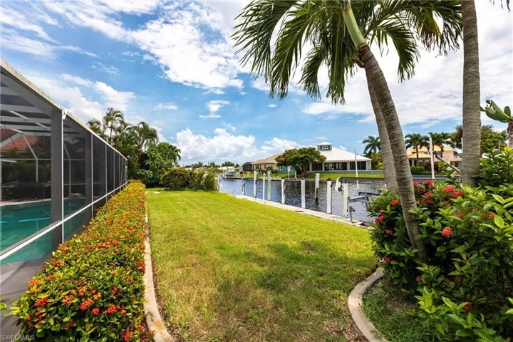 View of yard featuring a water view and a lanai