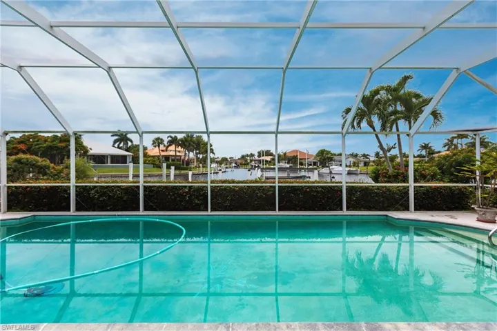 View of swimming pool with a lanai