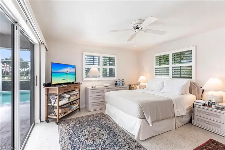 Bedroom with access to outside and ceiling fan