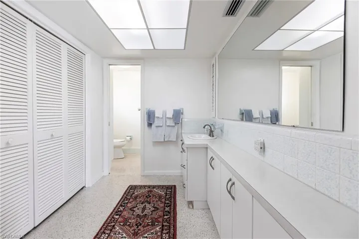 Bathroom with tasteful backsplash, toilet, and vanity