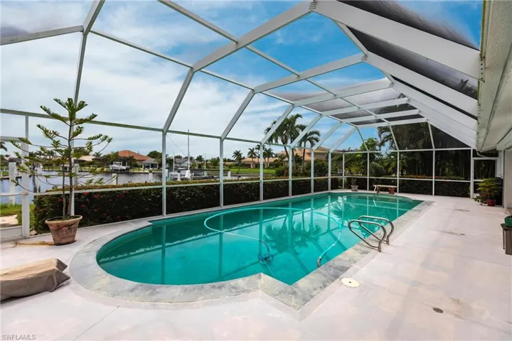 View of swimming pool with a lanai and a patio area