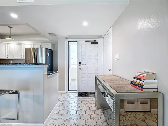 Kitchen with recessed lighting, appliances with stainless steel finishes, white cabinetry, ceiling fan, and dark stone counters