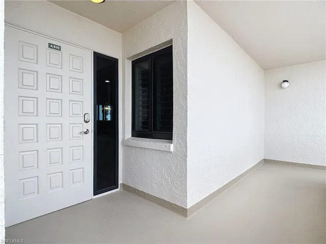 Entrance to property with stucco siding