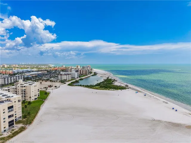 View of urban area featuring waterfront with a beach
