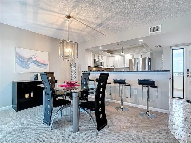 Carpeted living room featuring a textured ceiling and ceiling fan