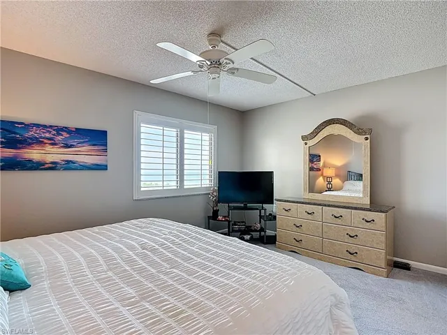 Bedroom featuring a textured ceiling and ceiling fan