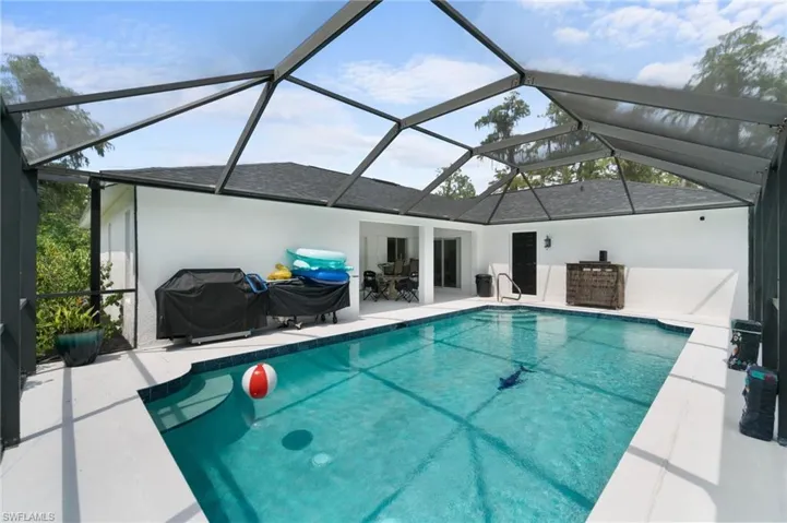 View of swimming pool with a lanai and a patio