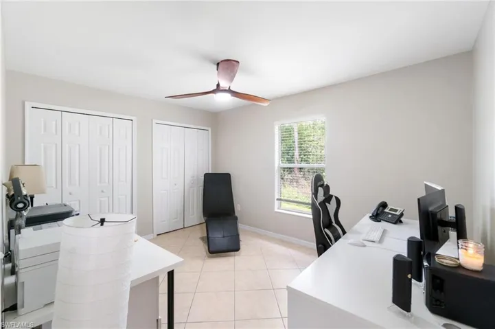 Office area/Bedroom with ceiling fan and light tile floors