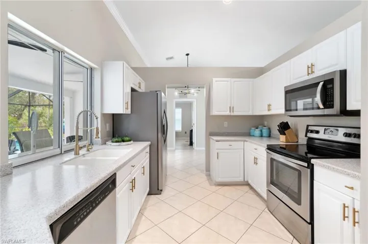 Beautiful light kitchen with a window to the patio
