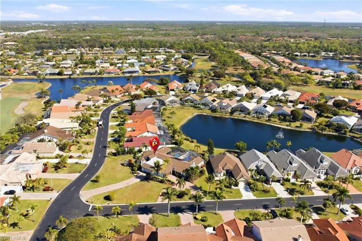 View of property location with a nearby body of water, nearby suburban area, and a local golf course
