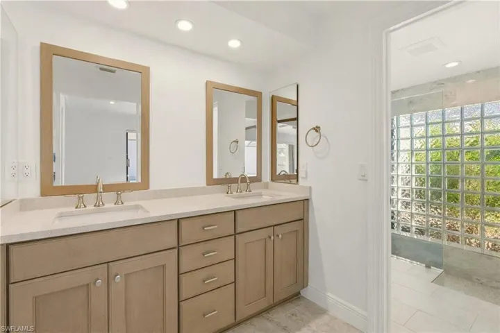Bathroom featuring double vanity and recessed lighting