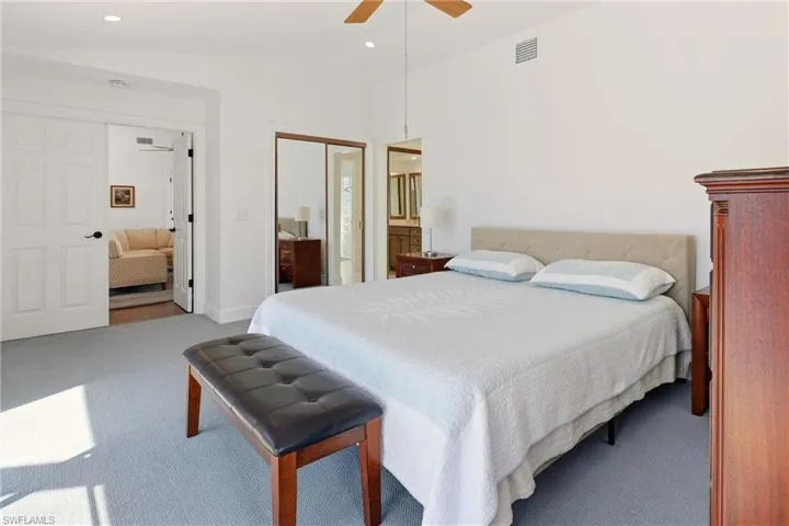 Bedroom with a closet, lofted ceiling, carpet, a ceiling fan, and recessed lighting