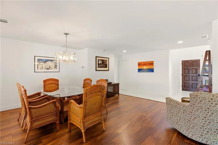 Dining space featuring dark wood-type flooring and a chandelier