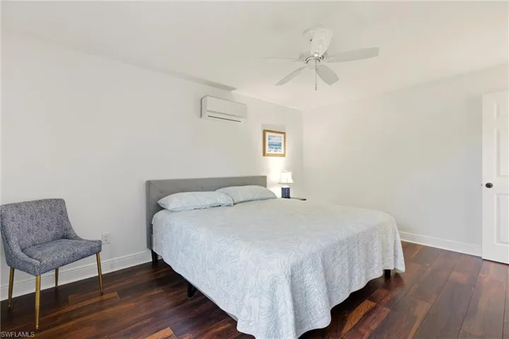 Bedroom featuring dark wood-type flooring and ceiling fan