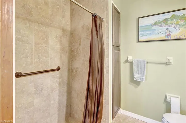 Bathroom with a shower stall, toilet