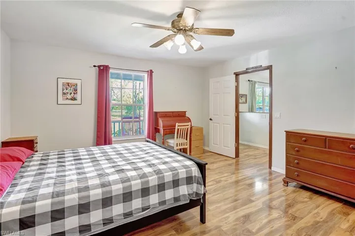 Bedroom with a ceiling fan, light wood-type flooring