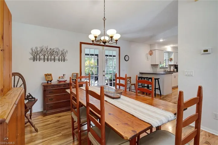 Dining room featuring French doors to the screened lanai and outdoor area