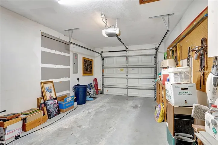 Garage with electric panel and a garage door opener