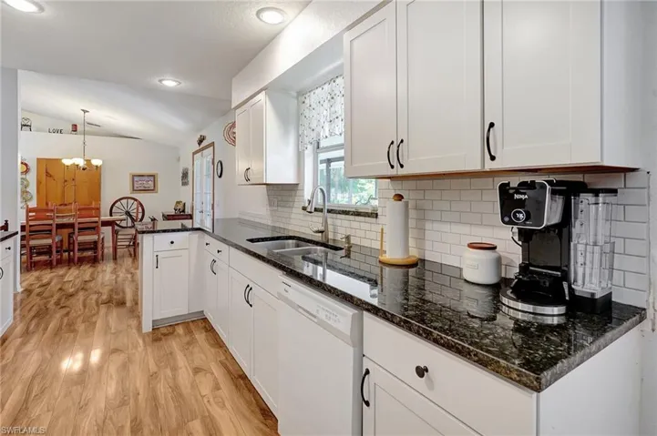 Beautiful Kitchen featuring light wood finished floors and lofted ceiling
