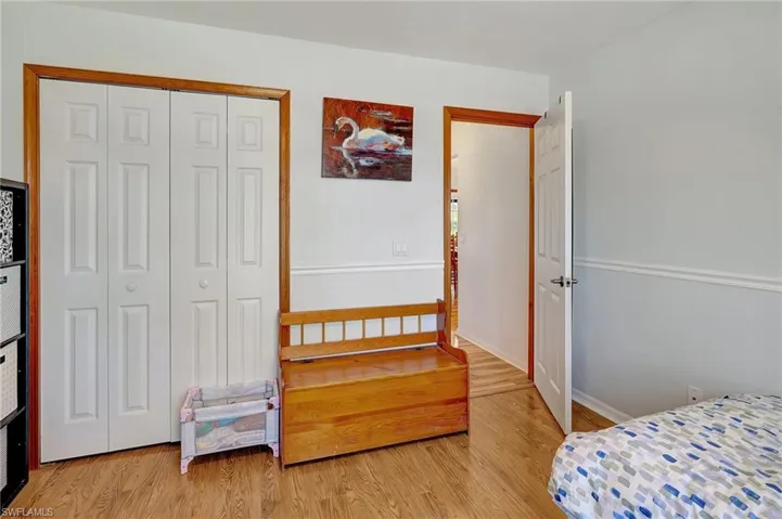 Bedroom with light wood-type flooring and a closet