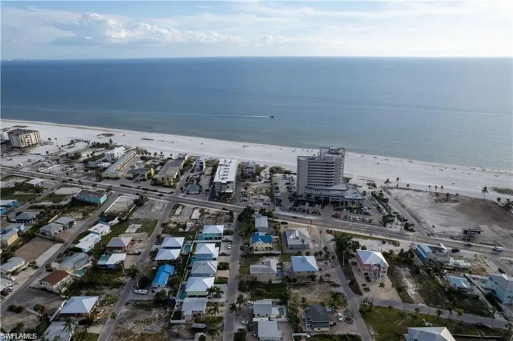 Aerial view featuring a beach view and a water view