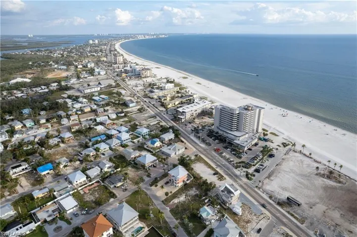 Birds eye view of property featuring a beach view and a water view