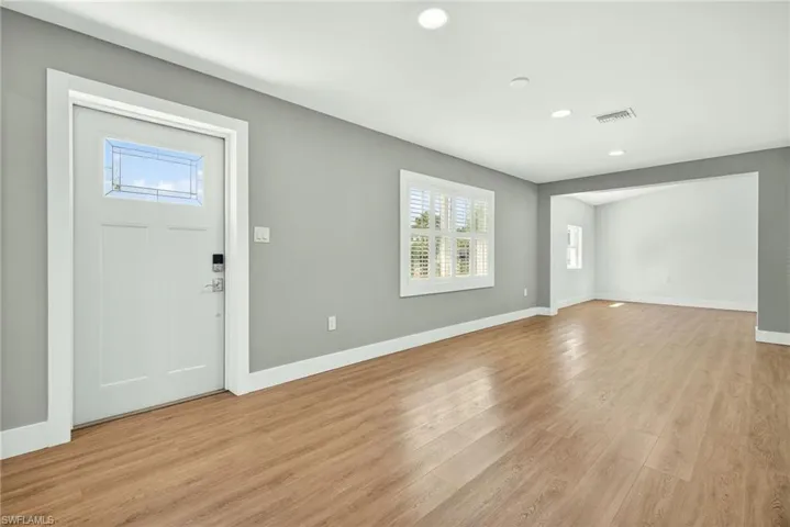 Entrance foyer with light wood-style floors and recessed lighting