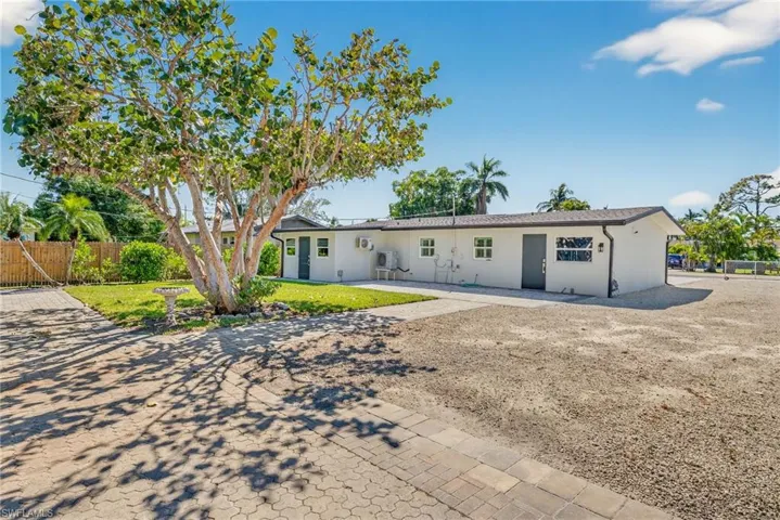 Ranch-style house featuring stucco siding