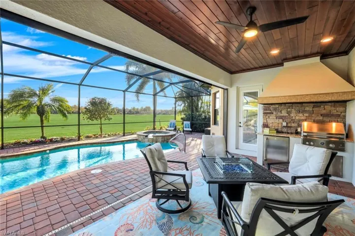 Welcome to your outdoor oasis complete with wood plank ceilings, recessed lights, summer kitchen and electric hurricane shutter!