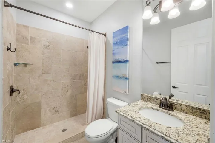 Guest bathroom #2 with walk-in shower with corner shelf and neutral finishes!