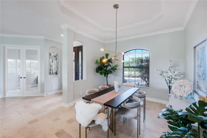 Open and airy dining area with modern chandelier.