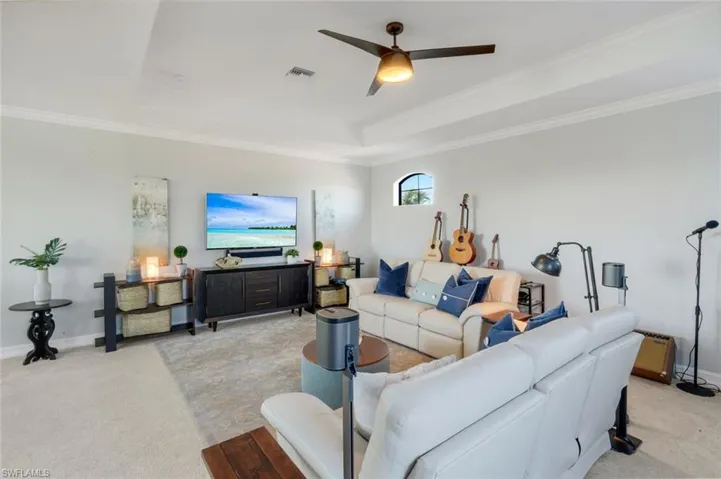 2nd story loft area- such a wonderful space to use as you please! Tray ceiling detail with crown molding, ceiling fan, windows and so much more!