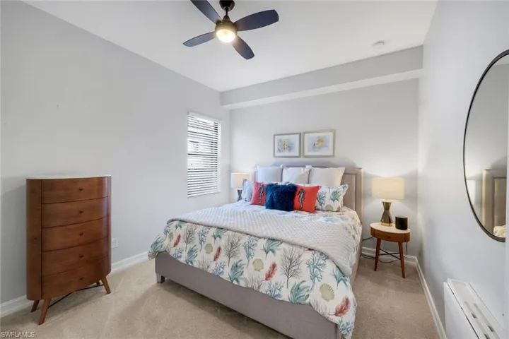 Guest bedroom #2 with ceiling fan/light and window allowing natural light to pour through!