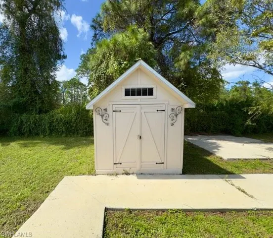 View of outdoor structure featuring a yard