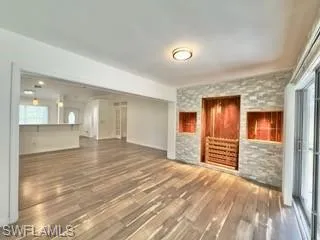 Unfurnished living room featuring dark hardwood / wood-style flooring