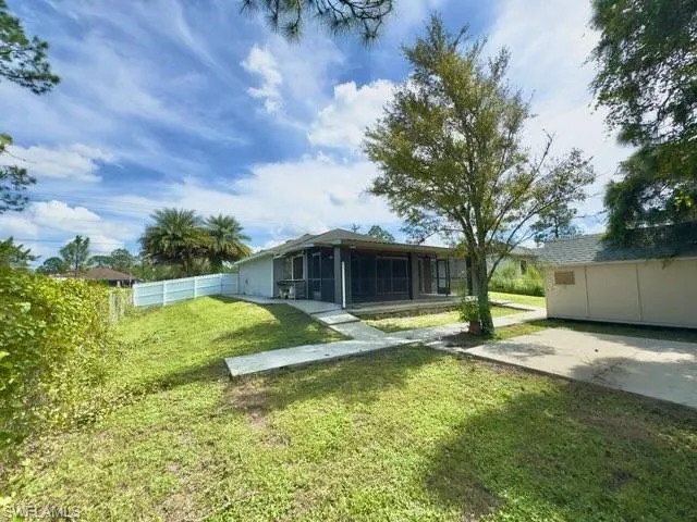View of yard featuring a sunroom