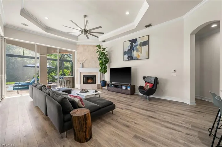 Living room with hardwood / wood-style flooring and a raised ceiling