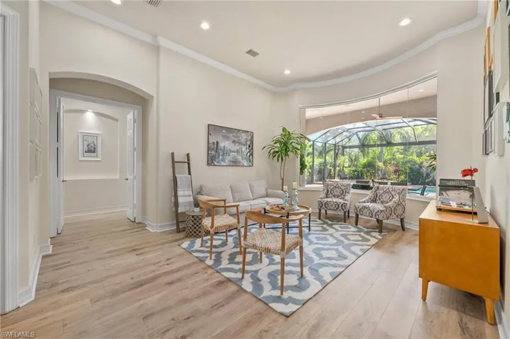 Living room featuring ornamental molding and light wood-type flooring