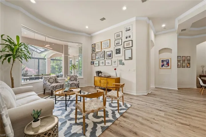 Living area featuring crown molding and light hardwood / wood-style floors